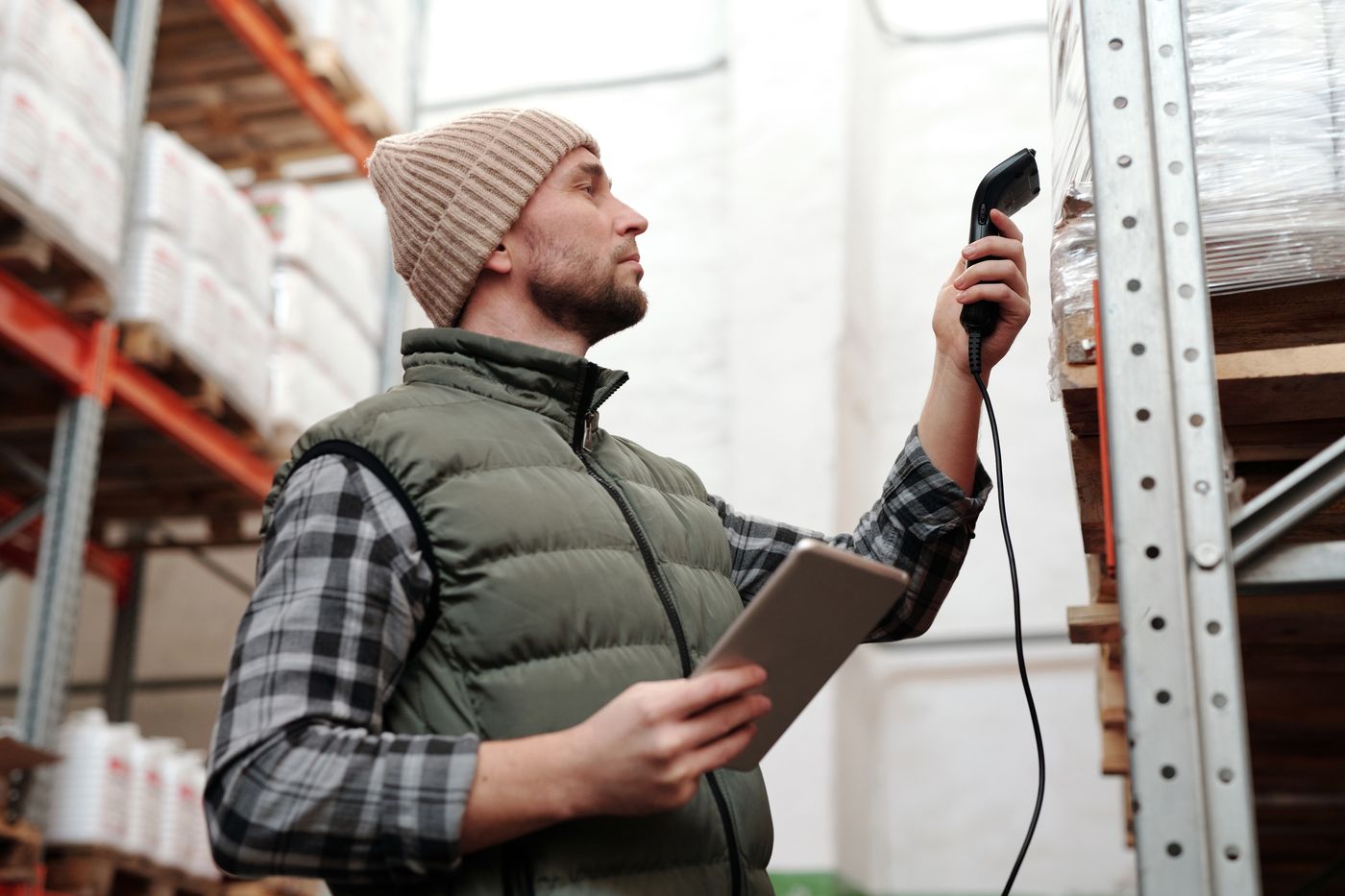 Warehouse worker scanning inventory with a handheld device